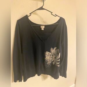 Black sweater with silver flower on front and back.